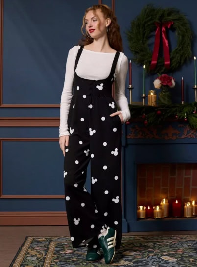 Cute Disney-themed fashion outfit featuring Mickey Mouse printed jumpsuit and cozy Christmas decor.