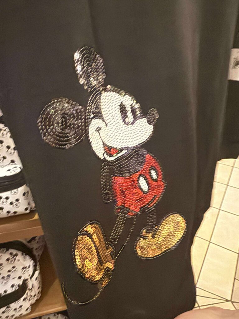 Sequin Mickey Mouse embroidery on black fabric, Disney-inspired fashion, playful and stylish Disney character design.