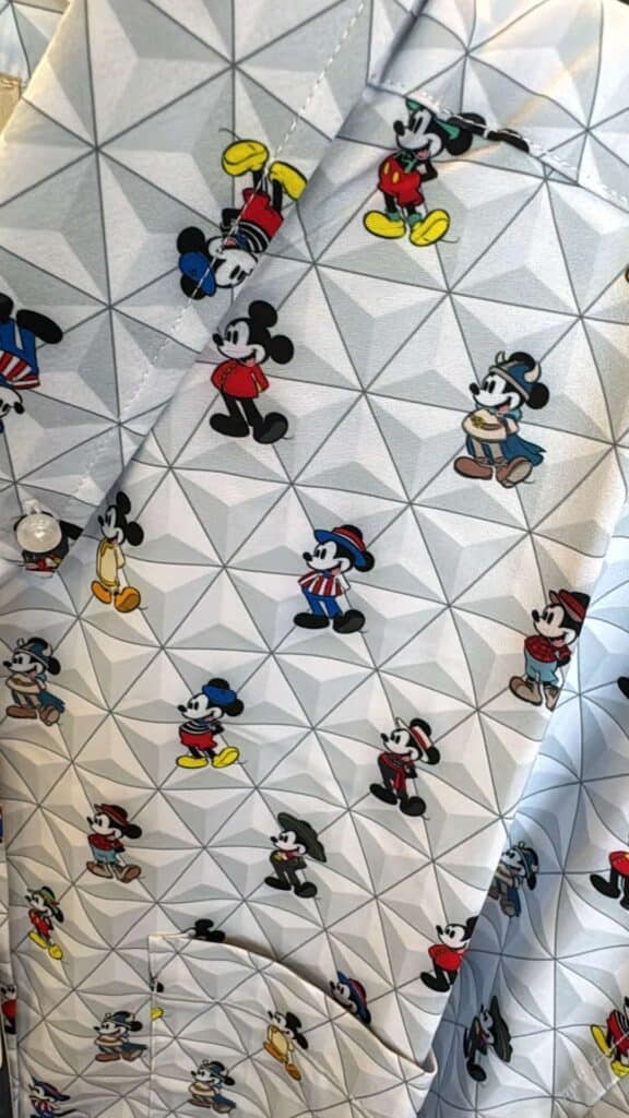 Colorful Mickey Mouse characters on geometric patterned fabric.