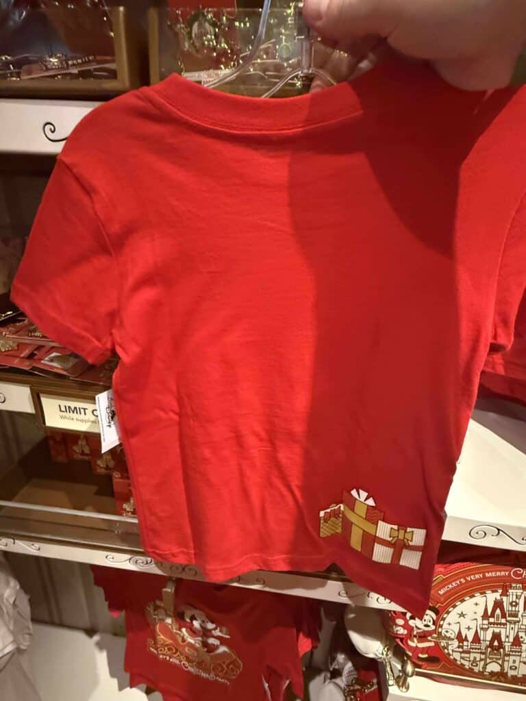 Red Disney Christmas-themed T-shirt with Mickey Mouse center graphic, festive holiday apparel for kids and Disney fans.