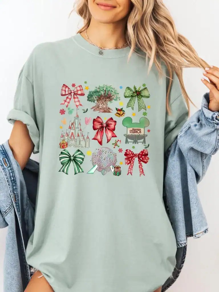 Colorful Disney holiday graphic t-shirt for women, featuring bows, castles, and ornaments for holiday cheer.