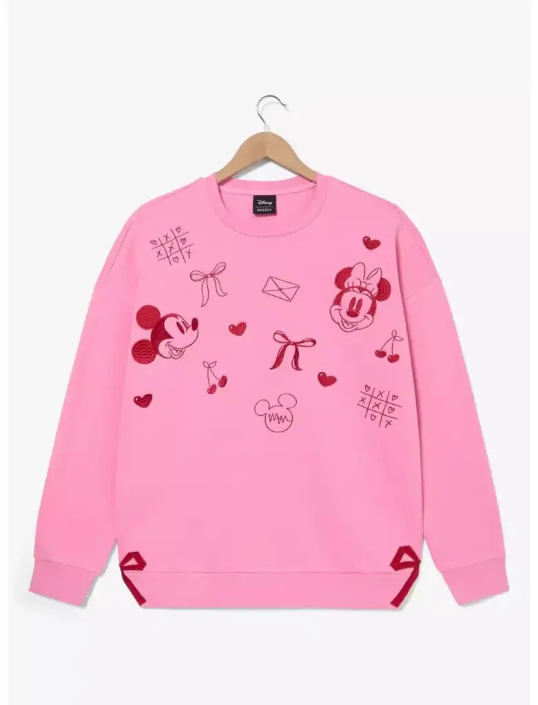 Pink Disney Minnie Mouse sweatshirt with playful graphics, hearts, bows, and game symbols.