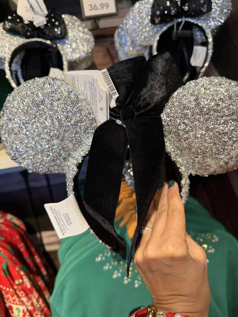 Sequin Mickey Mouse ears with black bow, perfect Disney fashion accessory for celebrations.