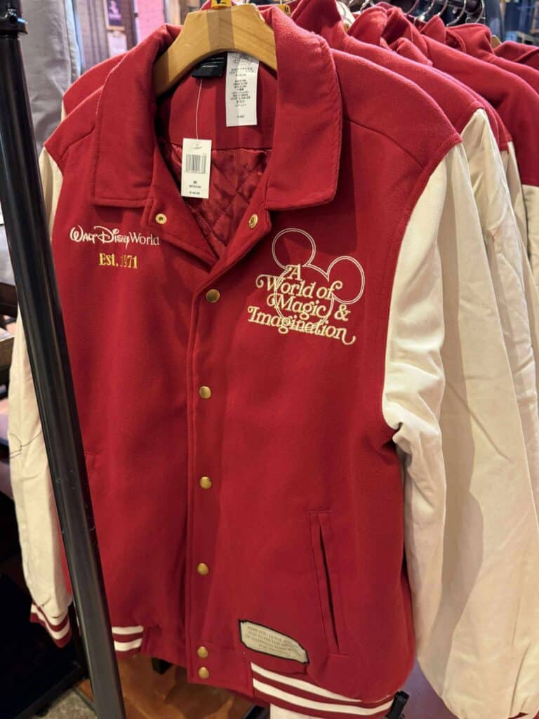 Stylish Disney varsity jacket featuring embroidered Disney-themed designs and vibrant red and cream colors.