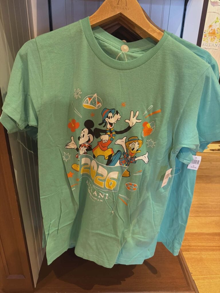 Bright turquoise T-shirt with Mickey, Minnie, and Donald celebrating summer. Perfect Disney resort and adventure wear.