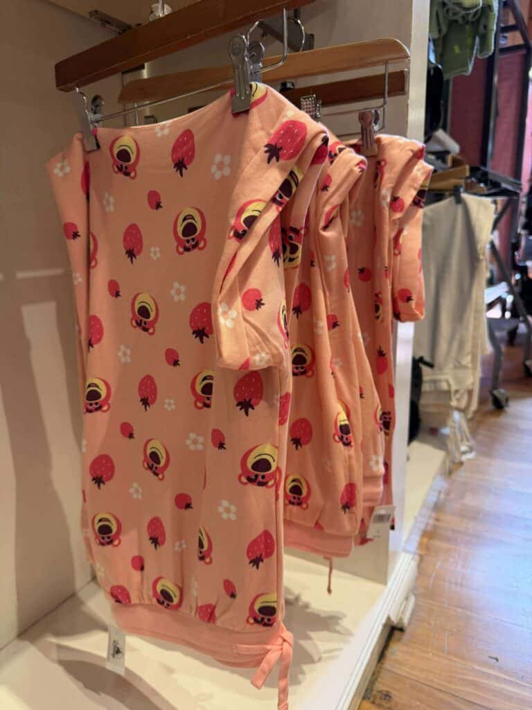 Cute Disney strawberry print pajamas in pink featuring favorite characters, perfect for lounge or sleepwear.