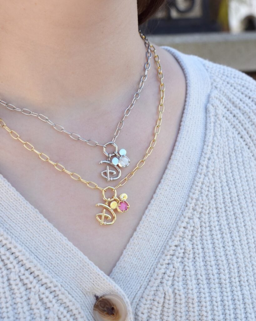 Delicate layered necklace with Disney-inspired charms and colorful accents, perfect for Disney fashion enthusiasts.