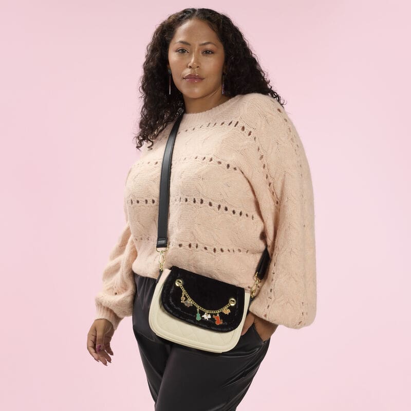 Colorful Disney-themed charms on a chic crossbody bag for Disney fashion lovers.