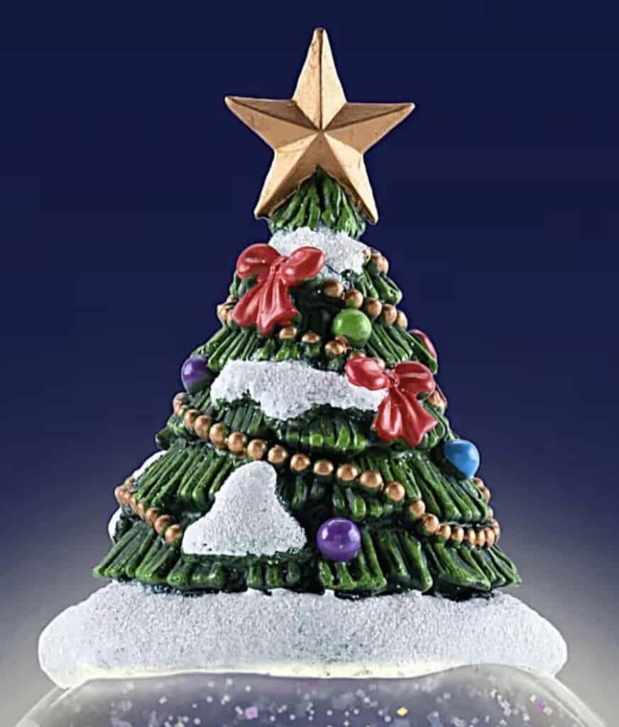 Festive decorated Christmas tree with colorful ornaments, ribbons, and a star topper. Perfect holiday centerpiece.