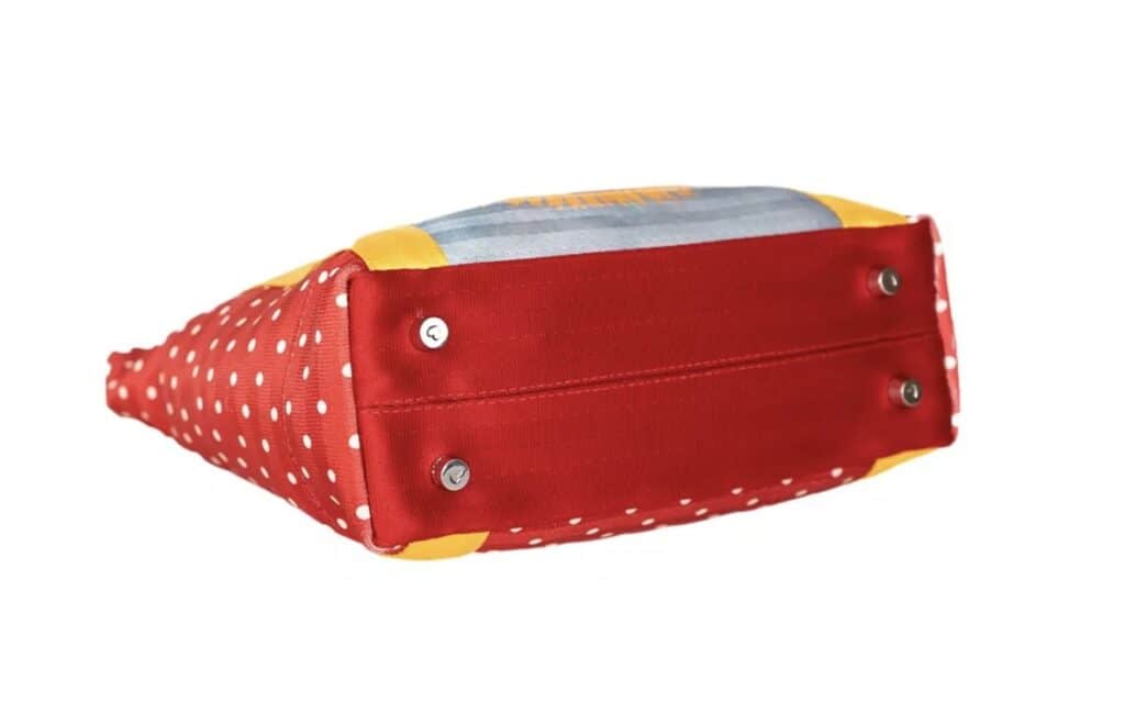 Vibrant red Minnie Mouse themed tote with polka dots and colorful design.