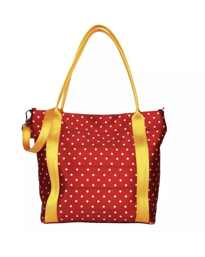 Bright red polka dot tote with yellow straps and accents, perfect for Disney fashion lovers.