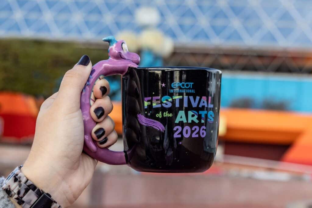 Colorful Disney-themed arts festival mug with Genie handle design.
