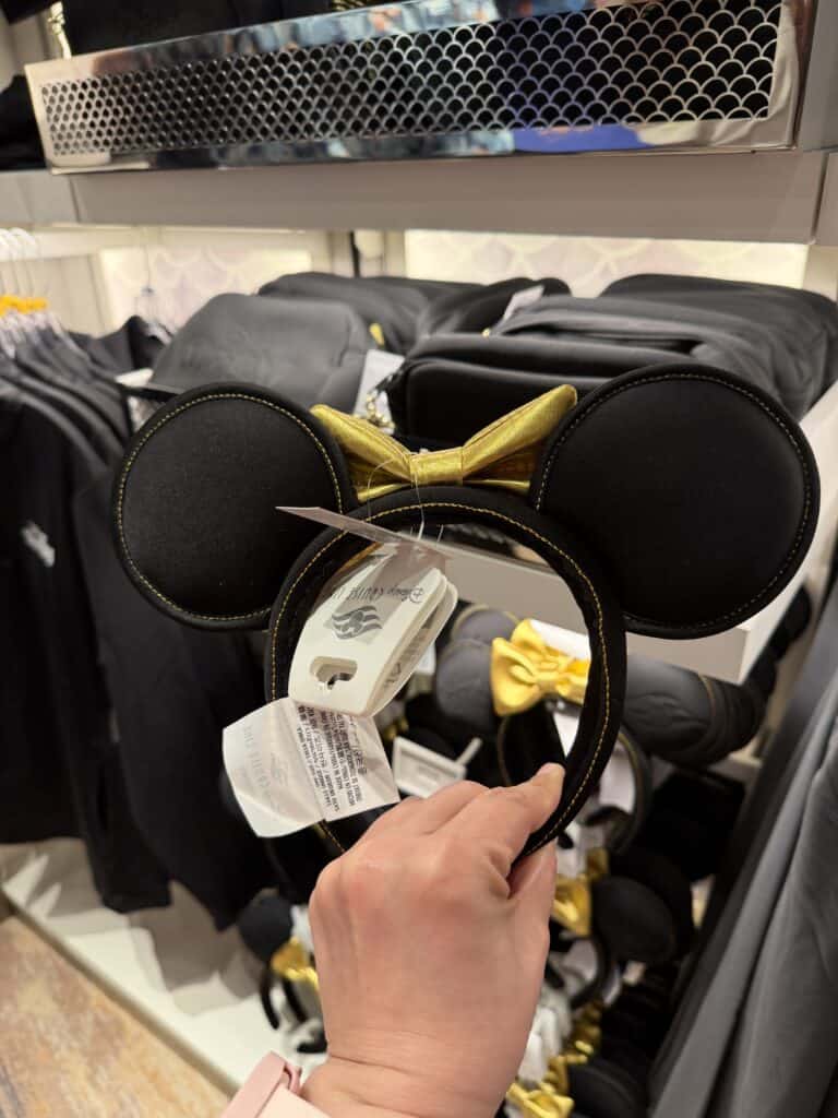 Minnie Mouse ears headband featuring a gold bow, ideal for Disney fans and costume accessories.