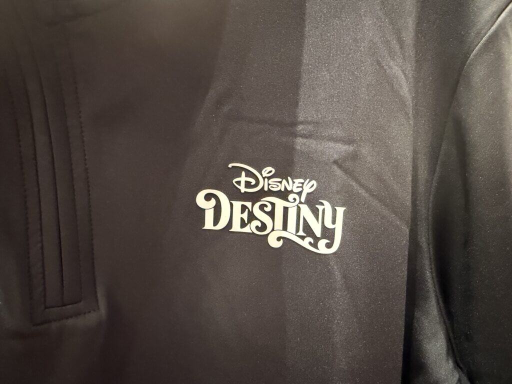 Logo of Disney Destiny printed on a sleek black bag, highlighting themed merchandise and accessories.