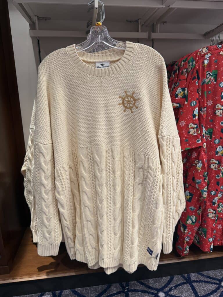 Soft cream cable-knit sweater with Disney Cruise Line emblem, perfect for Disney fans.