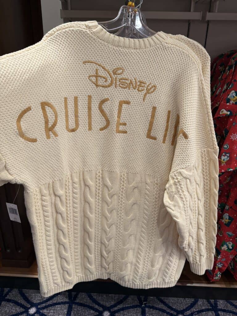 Disney Cruise Line cable knit sweater for Disney fans. Cream color with "Disney Cruise Line" embroidery, perfect for Disney-themed cancellations.