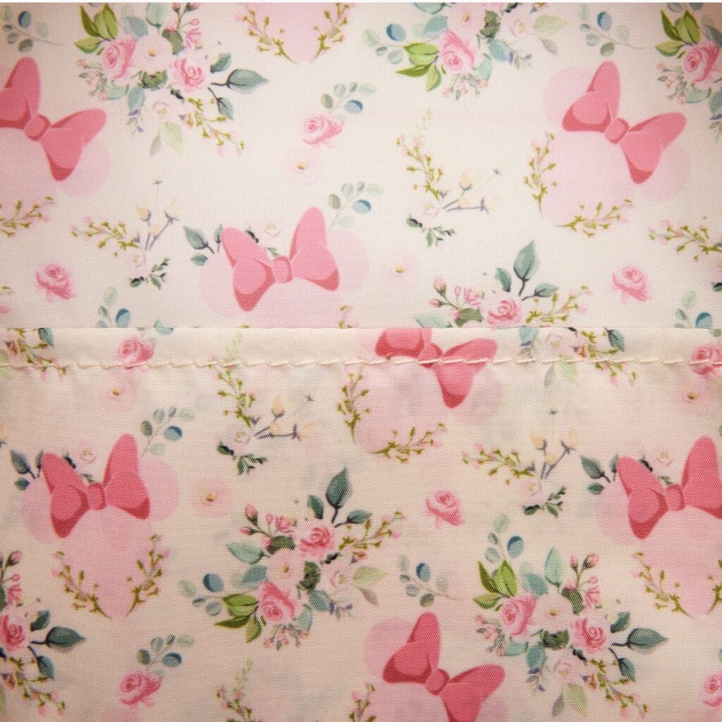 Soft pink butterfly and floral motif fabric for Disney-inspired fashion and accessories.