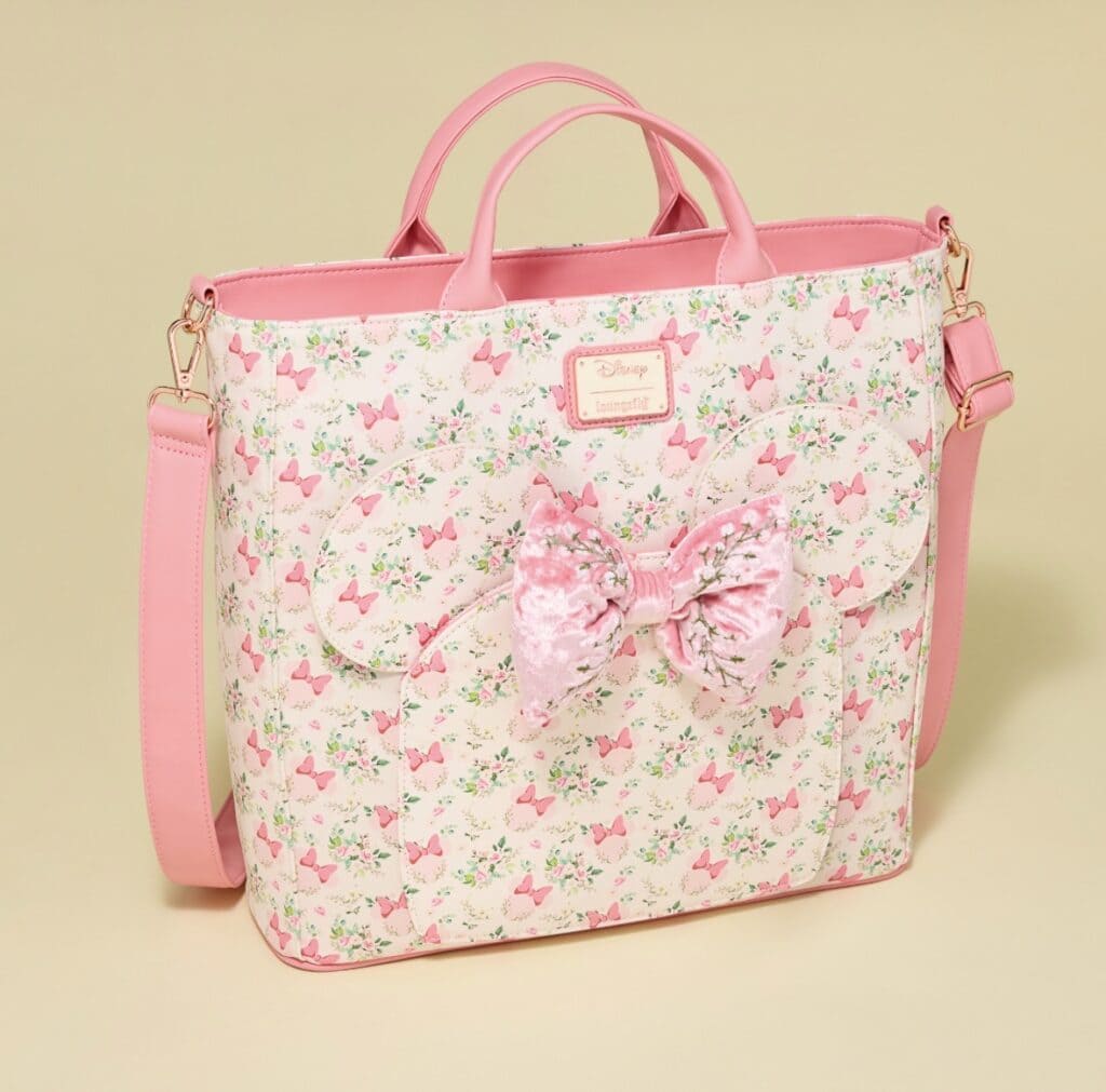 Pink Disney-themed tote with bow and butterfly print, perfect for fashion-forward Disney fans.