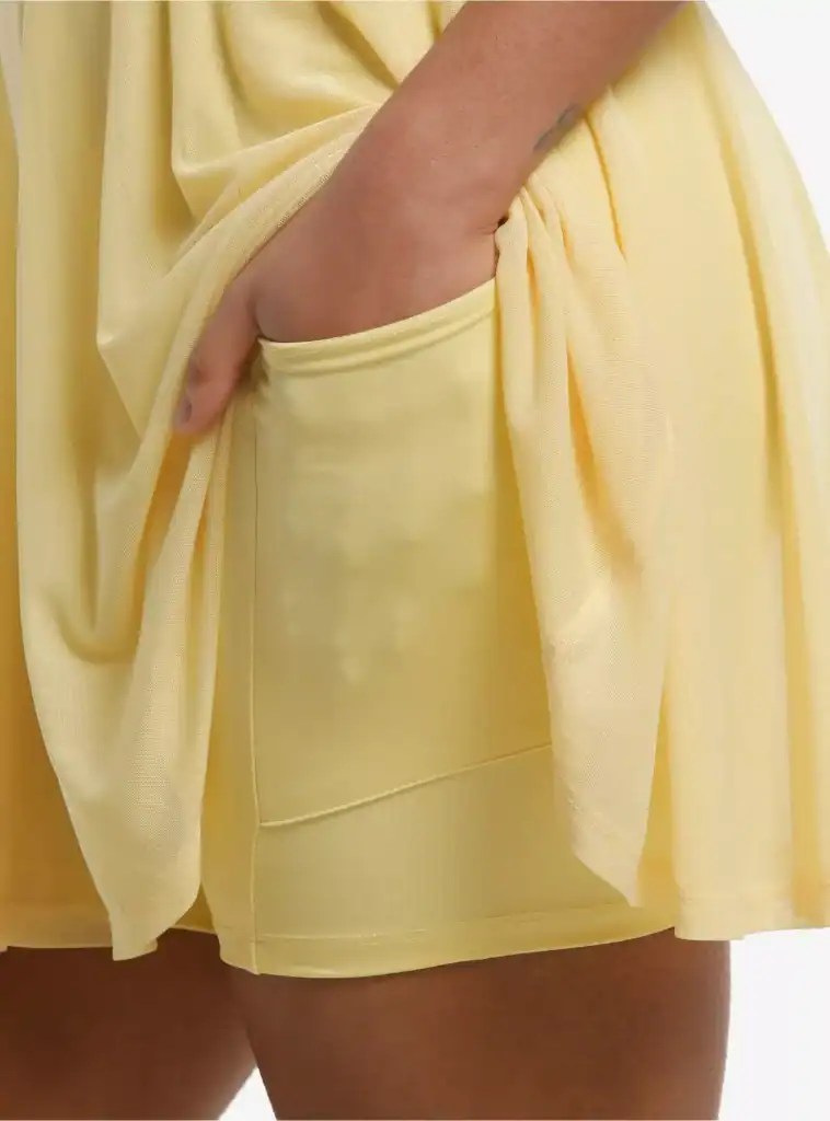 Stylish yellow Disney-themed shorts featuring side pockets and lightweight fabric.