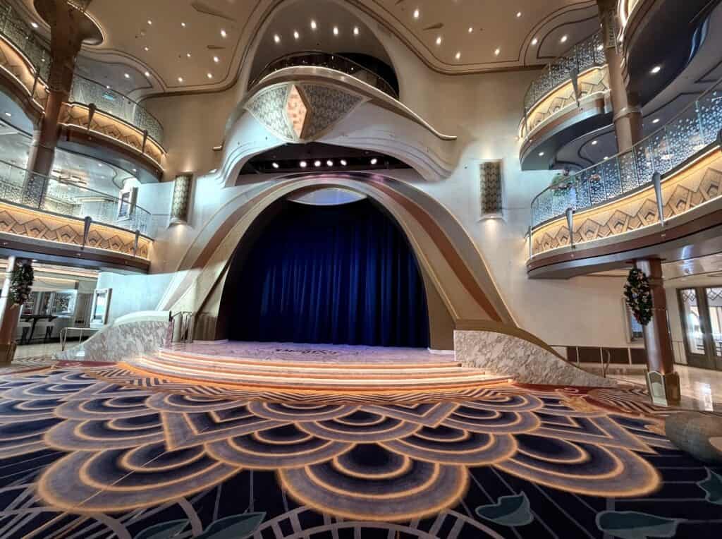Disney theater with a stunning stage, lush velvet curtains, and enchanting lighting for Disney shows.