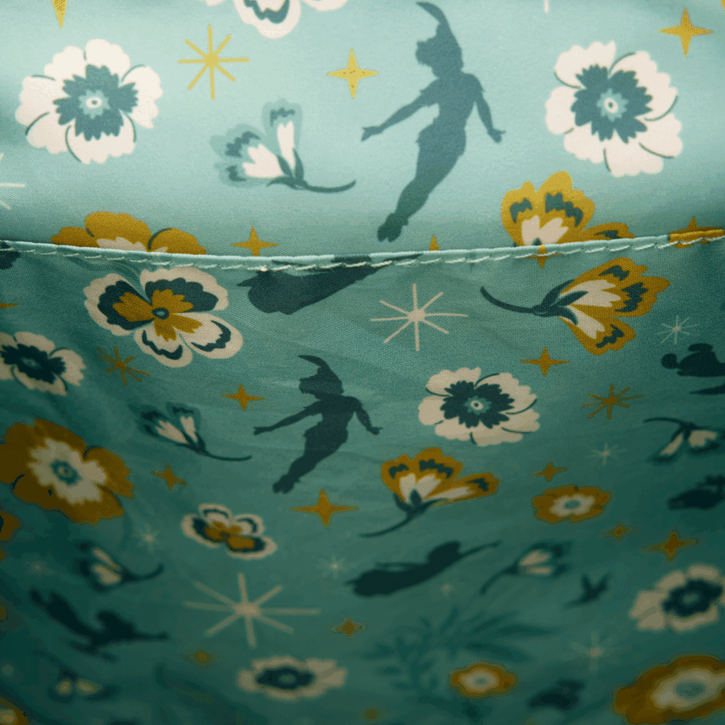 Enchanting Disney fairy-themed fabric featuring floral and star patterns, ideal for crafting and apparel.