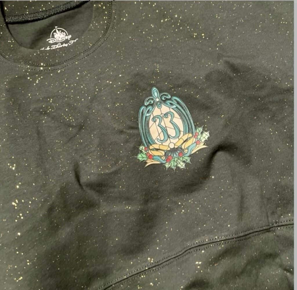 Disney holiday sweatshirt with holly wreath, number 33, glitter accents, perfect for festive Disney fashion.