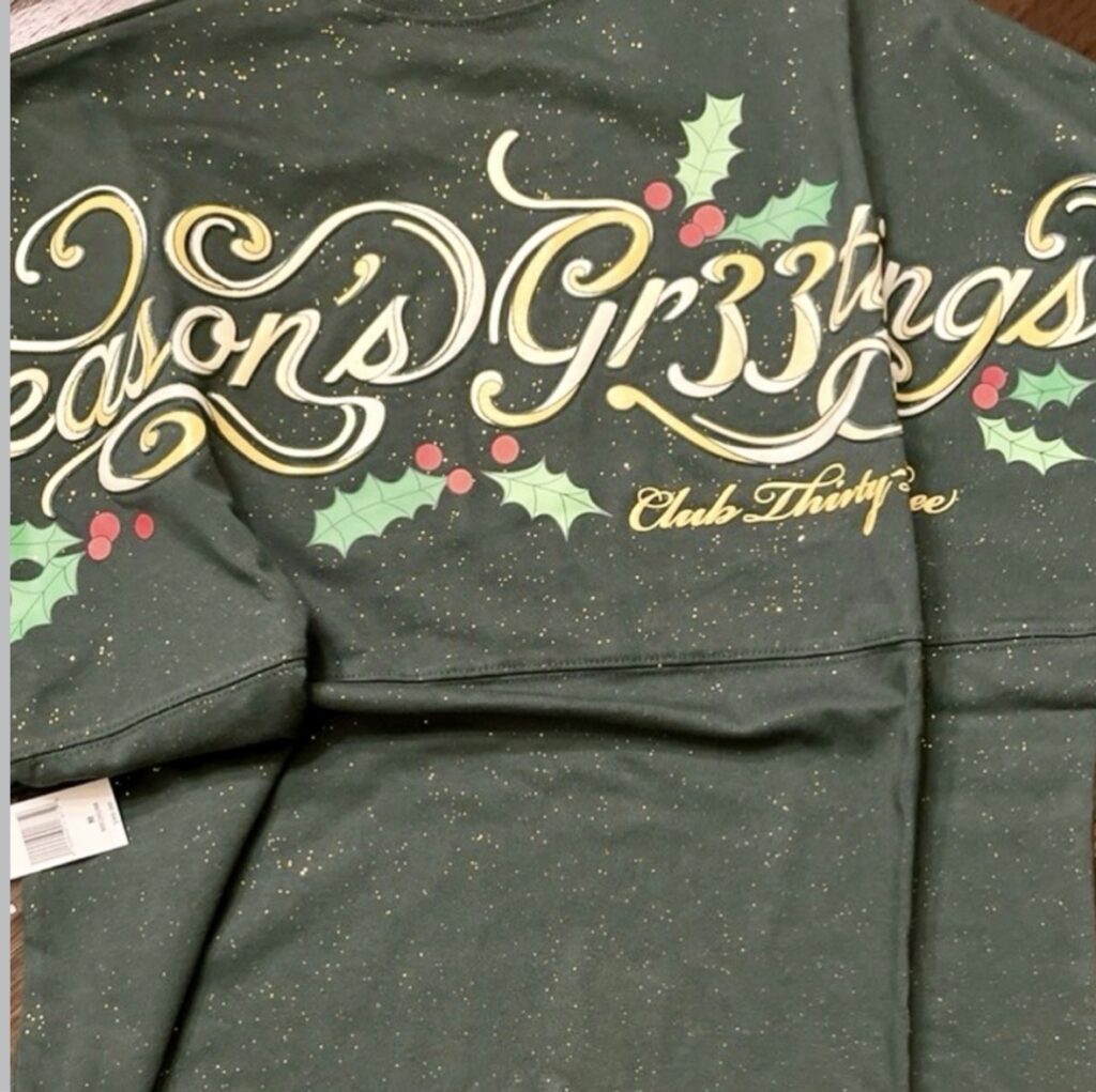 Festive Disney Christmas sweatshirt featuring holly and gold glitter for holiday cheer.