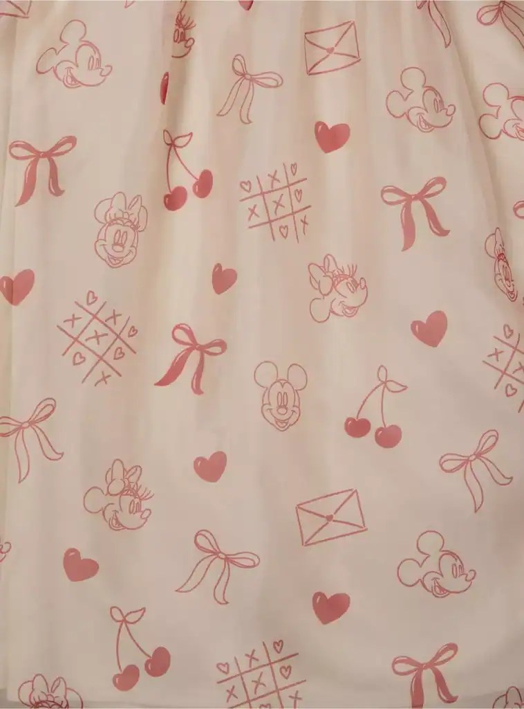 Cute Disney Minnie Mouse themed fabric featuring bows, hearts, and envelopes for kids' fashion and accessories.