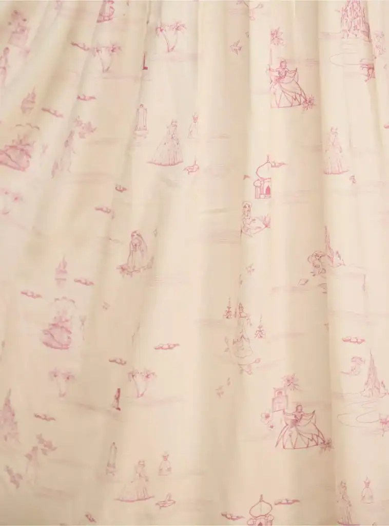 Soft pink Disney-inspired princess fabric featuring delicate illustrations of royal characters and fairy tale scenes.