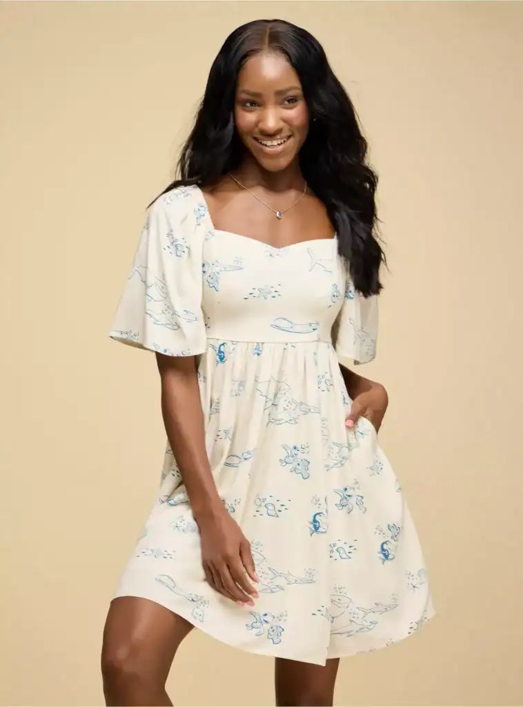 Elegant cream dress with blue sea animal print, perfect for Disney fashion lovers.