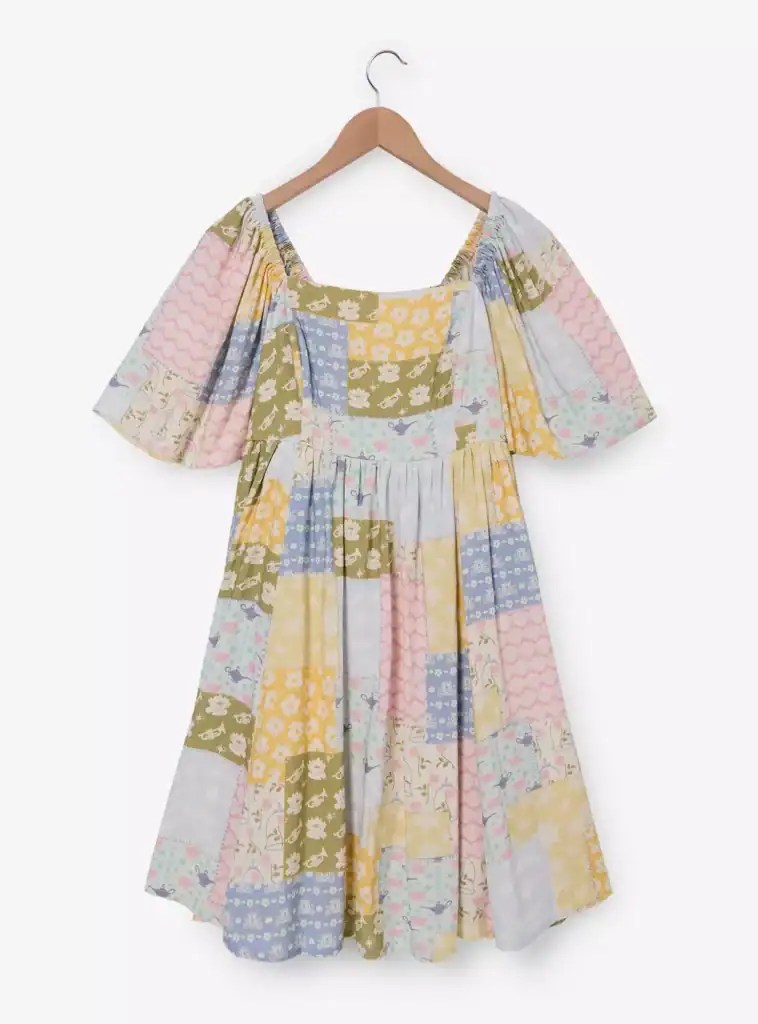 Bright, multi-colored Disney patchwork dress with ruffled sleeves and a flattering fit. Perfect for Disney fans and stylish fashionistas.
