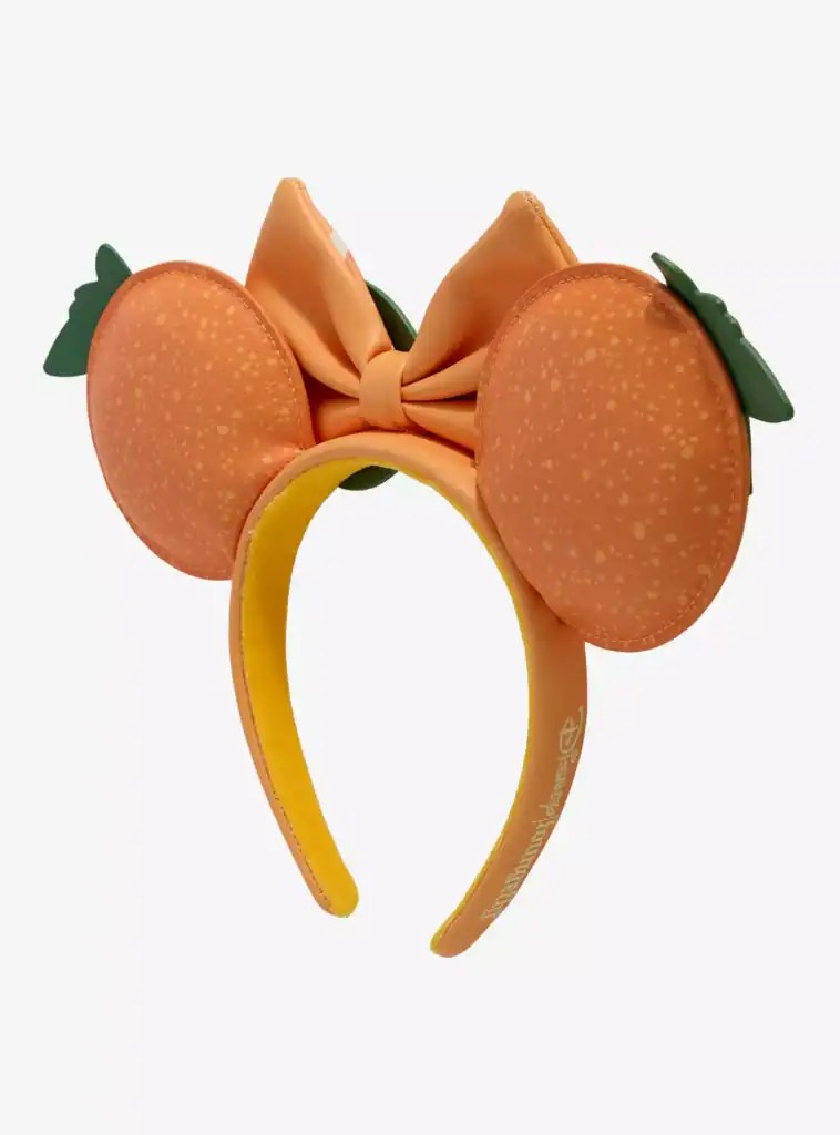 Bright peach-themed Minnie Mouse ears with a satin bow and green leaf accents.