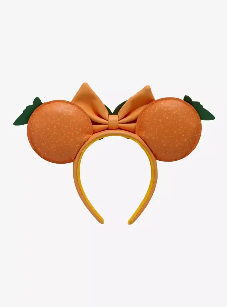 Disney Minnie Mouse ears headband with peach color, bow, and green leaf details.