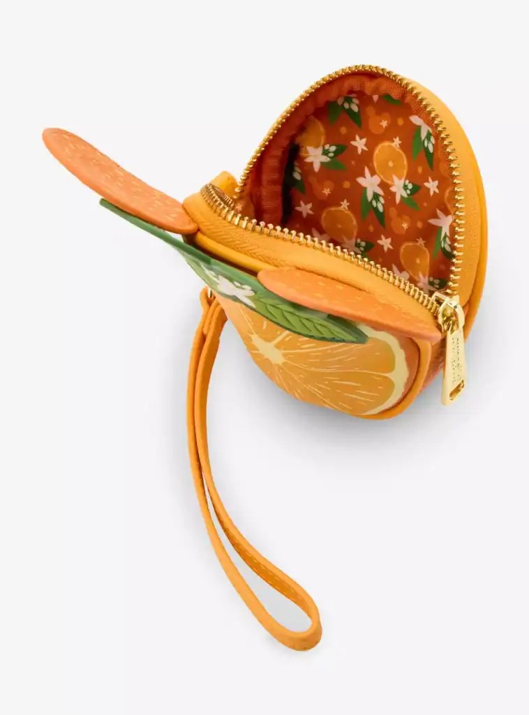 Bright orange mini backpack with citrus fruit print, gold zipper, and a detachable wrist strap, perfect for Disney fans and kids.