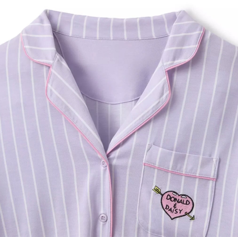 Cute purple Disney pajamas with pink trim, embroidered Donald and Daisy heart.