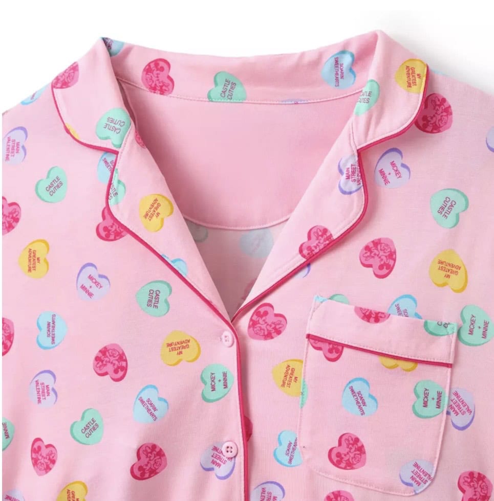 Cute pink Disney pajama top with colorful heart patterns featuring classic Disney characters and phrases.