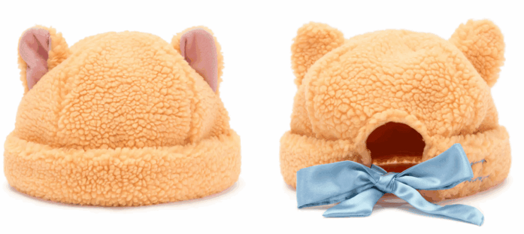 Cute peach-colored plush Minnie Mouse hat with ears, perfect for Disney fans.
