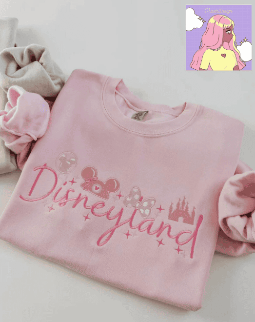Cute Disneyland-themed pink sweatshirt with Mickey Mouse and castle graphics. Perfect for Disney fans.