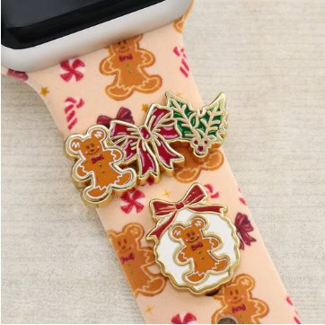 Decorative gingerbread, holly, and bow themed enamel pins for Christmas and holiday fashion accessories.