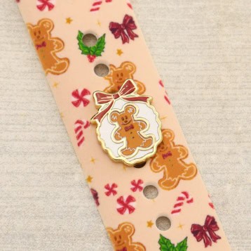 Cute gingerbread man themed enamel pin for holiday fashion.