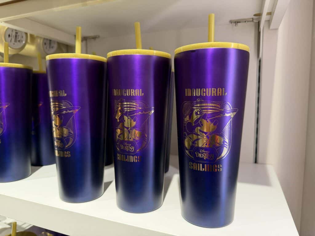 Bright purple Disney cruise-themed tumbler with Mickey Mouse illustration and yellow straw, perfect for Disney merchandise collectors.