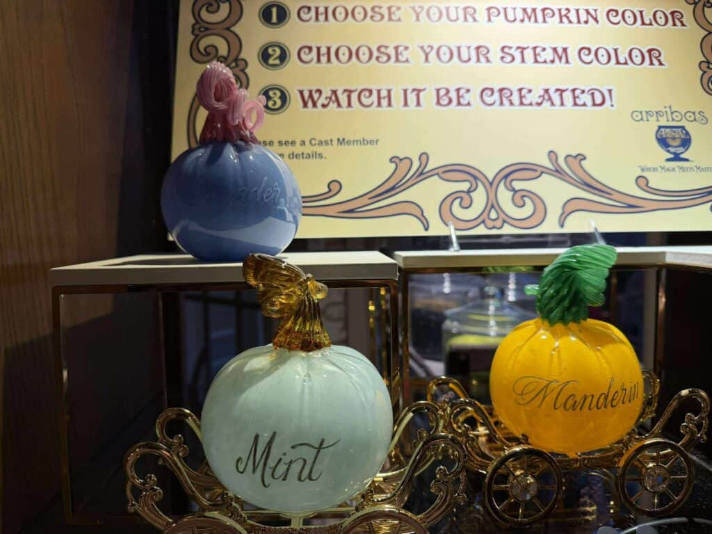 Detailed images of handcrafted, vibrant glass pumpkins featuring different colors and embellishments.