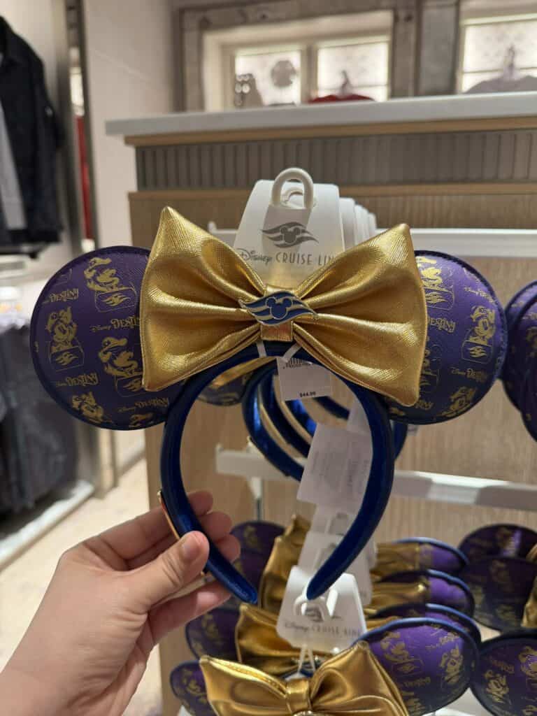 Disney Cruise Line themed Minnie Mouse headband with a shiny gold bow and purple ears, perfect for Disney fans.