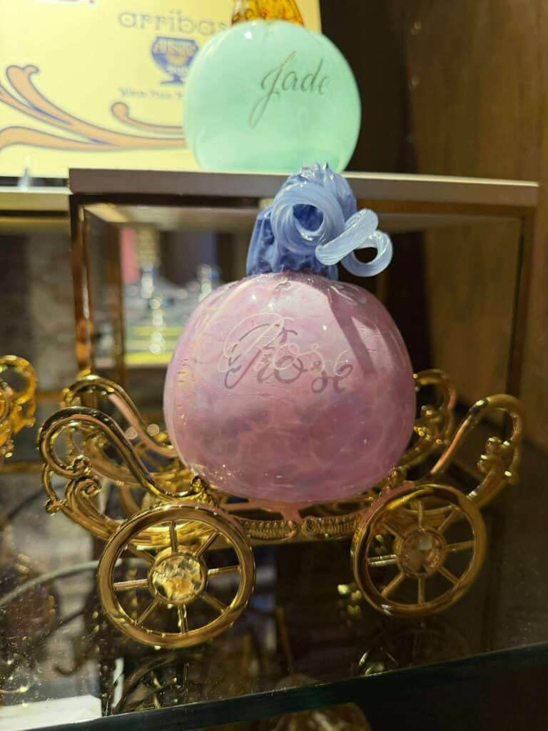 Delicate pastel-colored ornament with personalized "Jade" engraving, in a decorative gold carriage display.