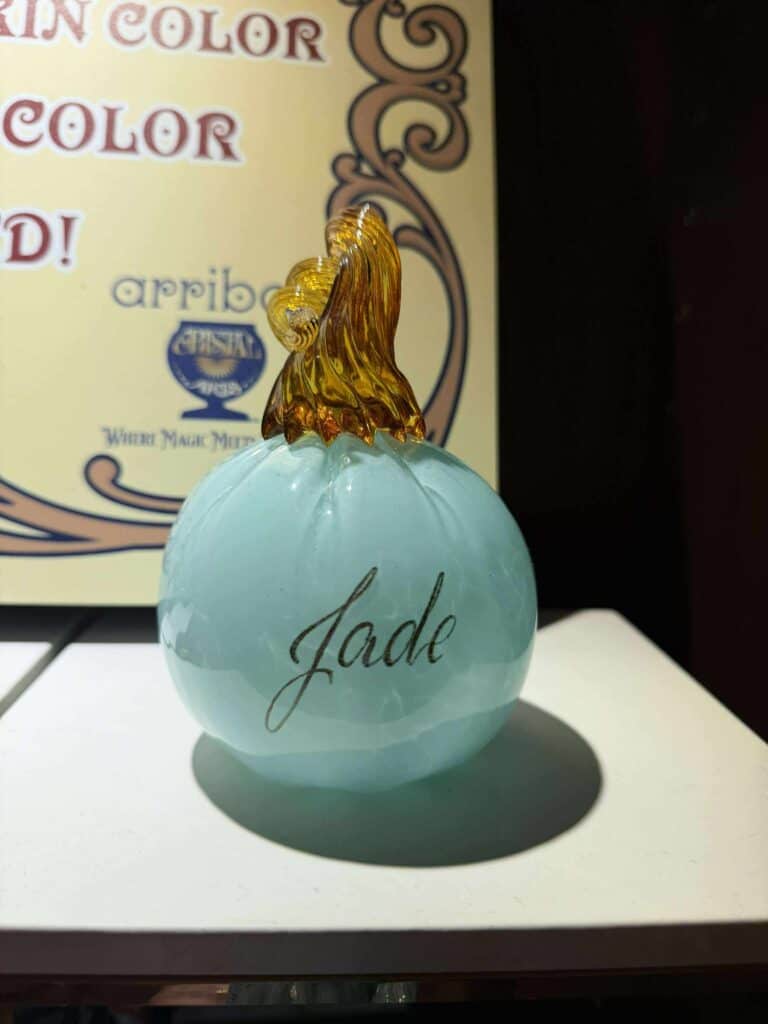 Disney perfume bottle with "Jade" inscription, featuring a glass pumpkin design inspired by Disney and Disney Princess collectibles.