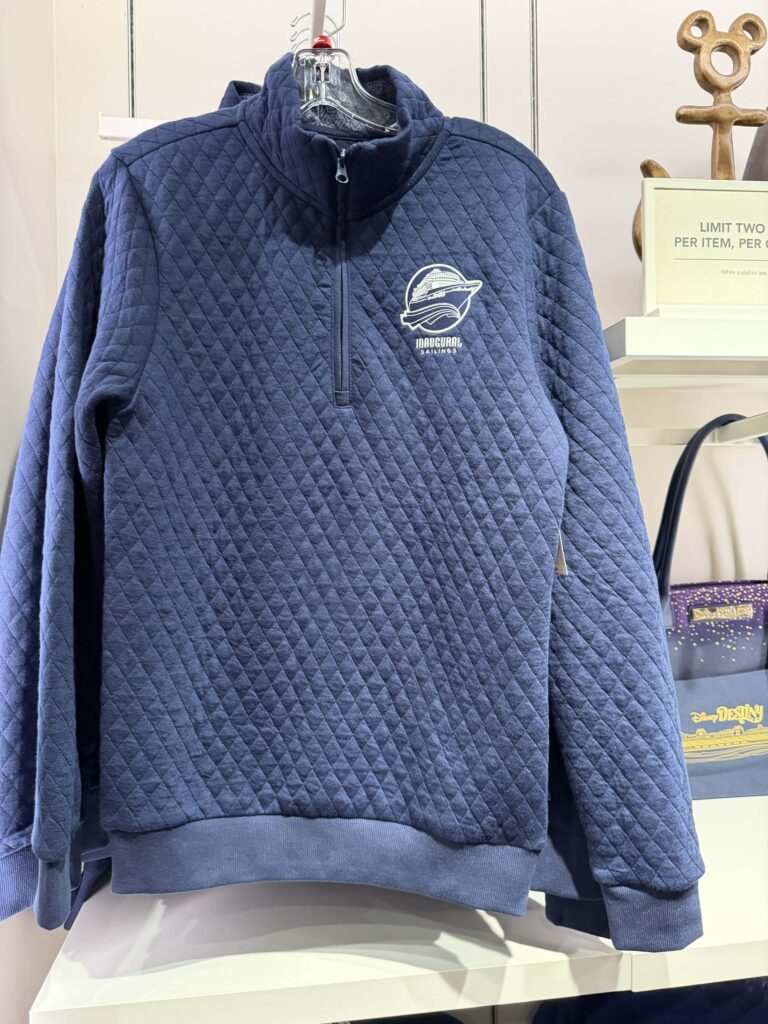 Blue quilted Disney inaugural sailing sweatshirt with logo.