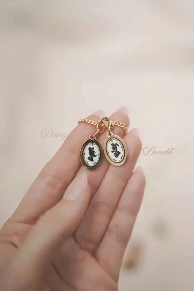 Gold-tone Mickey and Minnie Mouse cameo pendants, Disney-inspired fashion accessory.