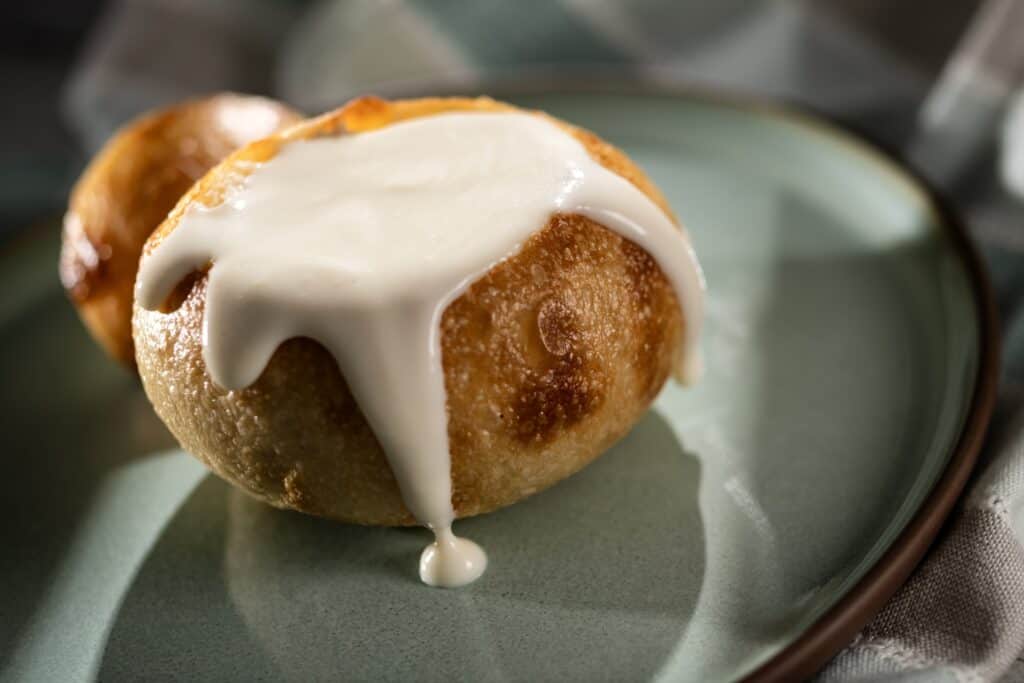 Delicious cinnamon roll topped with creamy white icing, fresh from the bakery. Perfect treat for breakfast or dessert.