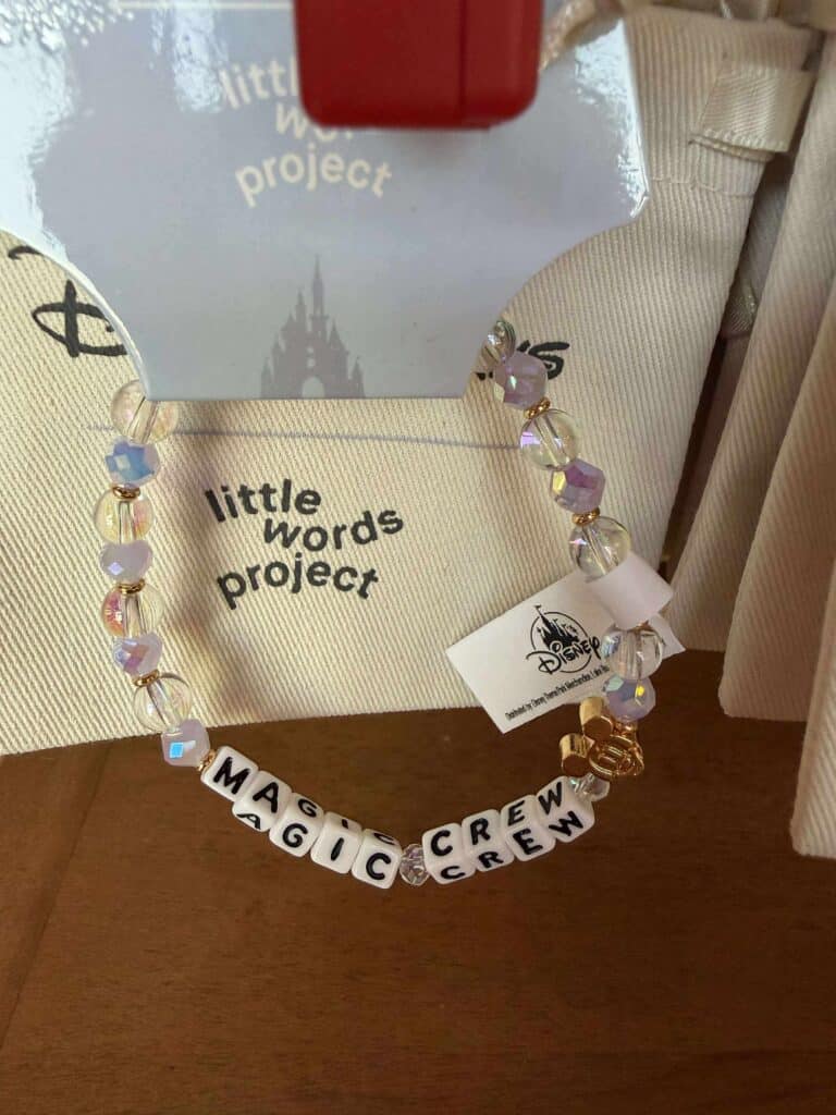 Beautiful Disney-inspired bracelet featuring iridescent beads, Mickey Mouse charm, and custom "Magic Crew" letter beads.
