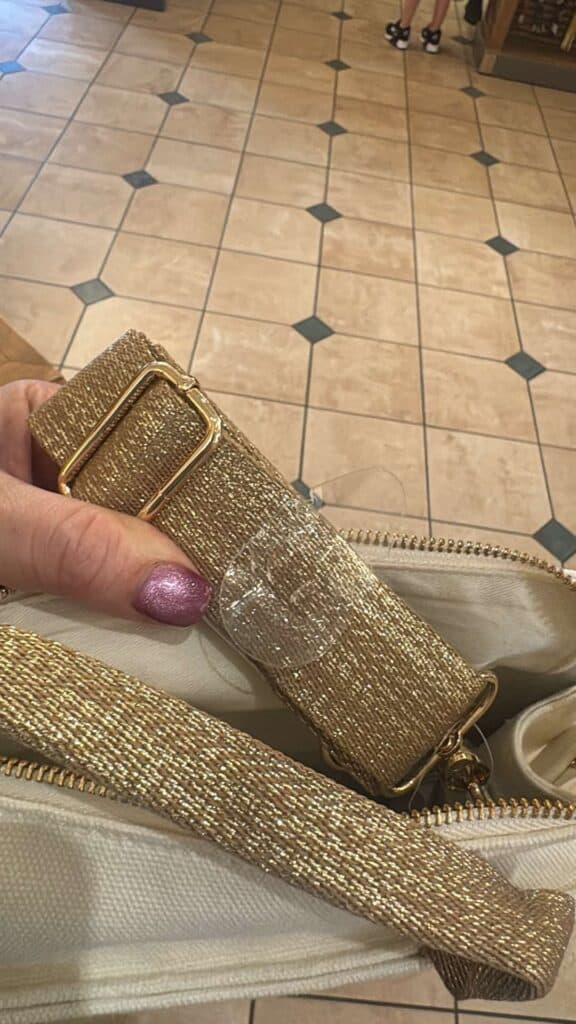 Shiny gold fashion belt with textured glitter design for stylish outfits.